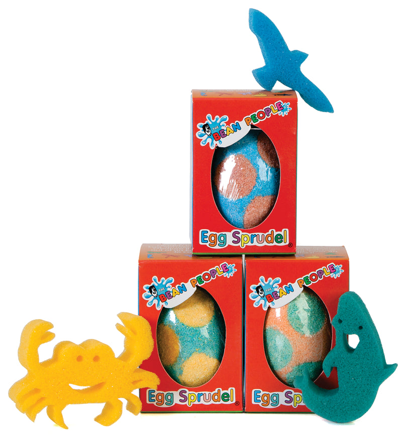 Three Egg Bath Bomb Sprudels in red packaging stacked with crab, fish and bird sponge toys