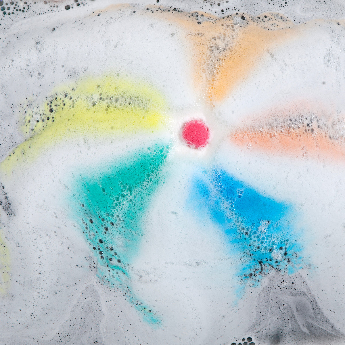 Rainbow Star Sprudel fizzing in white foam with a pink centre and blue and yellow swirls
